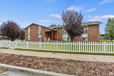 View of front of home with brick siding and a fenced front yard
