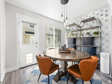 Dining space with wood finished floors and plenty of natural light