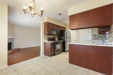 Kitchen with a sink, visible vents, black applian