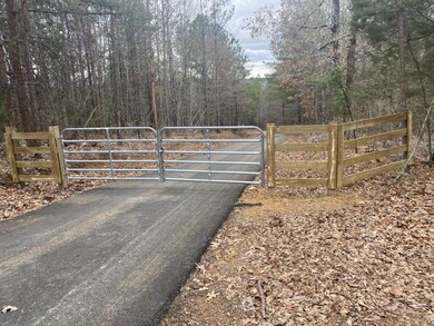 View of gate featuring a view of trees