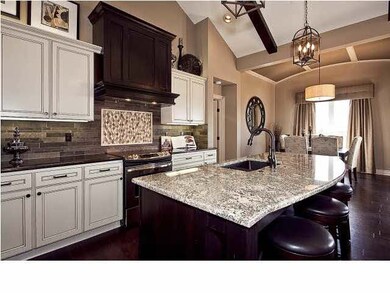 This model showcases unique backsplash and granite