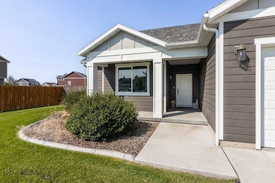 View of exterior entry with a mature landscape
