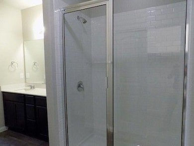 Full bathroom with vanity and a stall shower