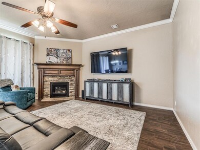 Living room featuring a ceiling fan, visible vents