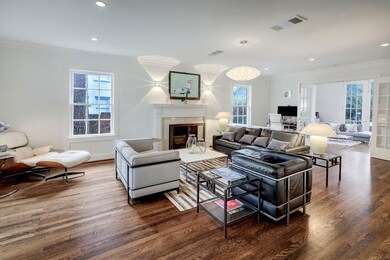 Just off the entryway is the spacious living room that features a fireplace with gas inlet, several large windows and divided light French doors leading to the spacious den.