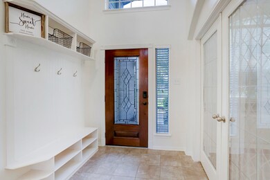 Another view of the foyer just outside of the study/office there is a built-in bench, storage for shoes and backpacks along with hooks for jackets and coats.