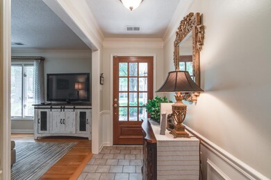 Entryway featuring crown molding, a textured ceili