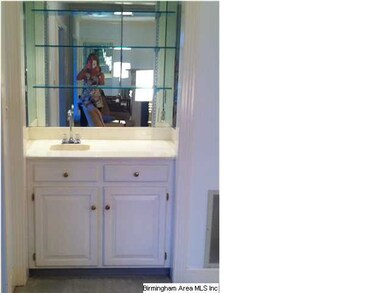 WET BAR IN LIVING ROOM WITH GLASS SHELVES