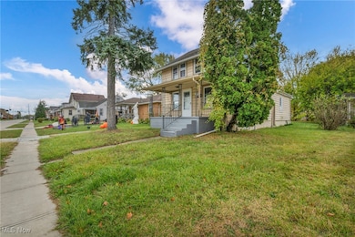 View of front facade featuring a front lawn and covered porch