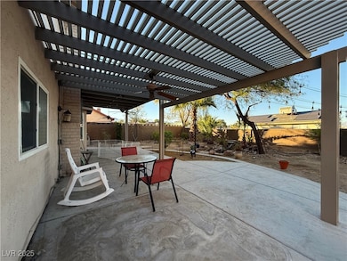 Fenced backyard featuring a patio area, outdoor dining space, a pergola, and a ceiling fan