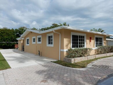 Left side of house with concrete driveway to boat ramp