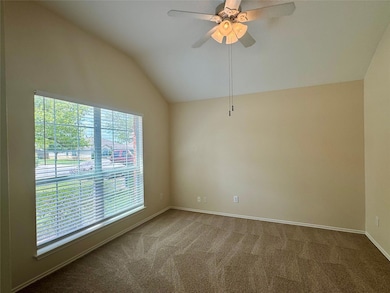 Spare room with vaulted ceiling, carpet, and ceil