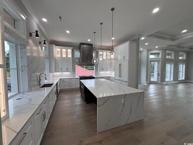 Kitchen featuring a wealth of natural light, a cen
