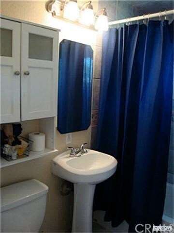 Remodeled bathroom with pedestal sink.