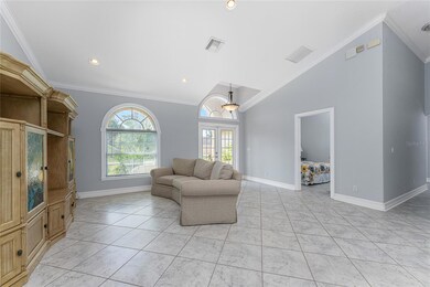 The living room has a pretty arched window.