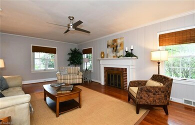 Spacious Living Room with gas logs and hardwood floors.