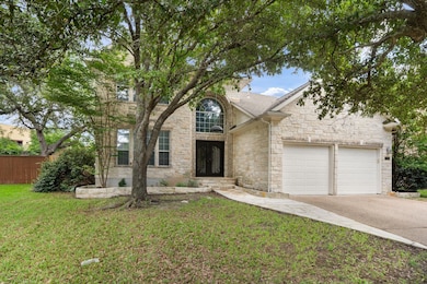 Traditional-style home with stone siding, drivewa