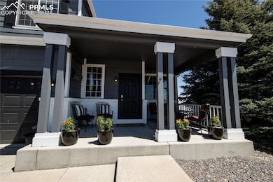 Property entrance with a porch, brick siding, and 