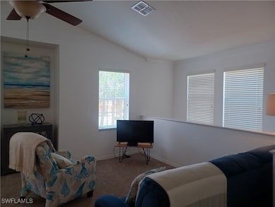 Living room featuring carpet, baseboards, and a ce
