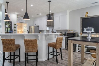 Kitchen featuring backsplash, pendant lighting, li