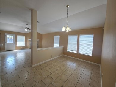 Unfurnished room with plenty of natural light, a chandelier, light tile patterned floors, ceiling fan, and lofted ceiling