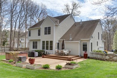 Back of property with a yard, fence, a hot tub, an
