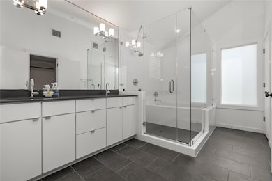 Full bath with double vanity, a stall shower, til