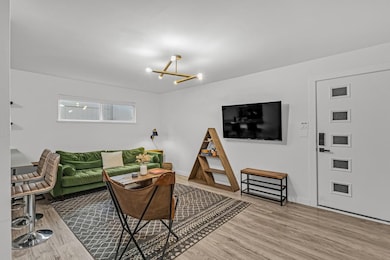 Living room with baseboards, a notable chandelier