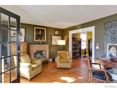 Original details and chunky moldings in lovely living room.