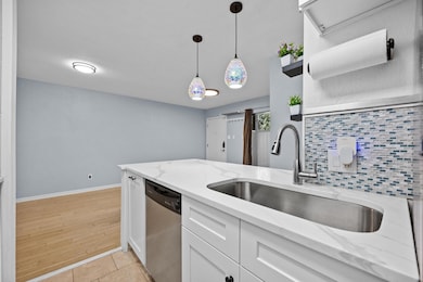 Kitchen featuring stainless steel dishwasher, a s