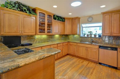 Chef's kitchen, Maple cabinets with deep drawers and pullout shelves, spice cabinet, granite counters, garden window, stainless sink, refrigerator, pantry and wood floors.
