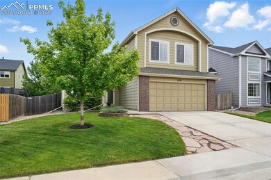 View of front of home featuring brick siding, concrete driveway, and a garage