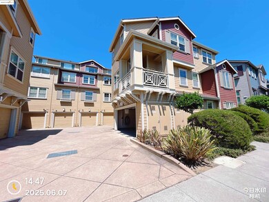 View of building exterior featuring driveway, an attached garage, and a residential view