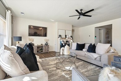Living room featuring wood finished floors and a ceiling fan
