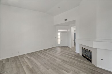 Unfurnished living room with a fireplace, light wo