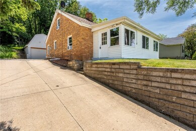 View of front of house featuring an outdoor structure and a garage