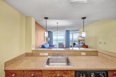 Kitchen with dishwashing machine, a textured ceili