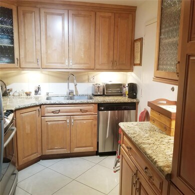 Custom made wood cabinets, stainless steel appliances and granite counter