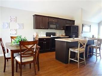Open kitchen with custom cabinets and work island.