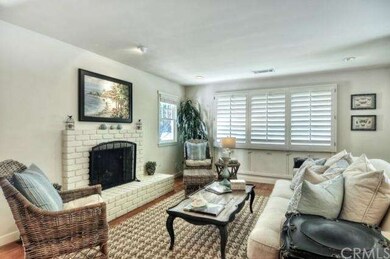 Front living room with brick fireplace.