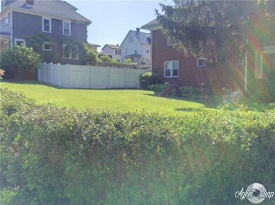 View of large level yard. Nice white vinyl fenced 