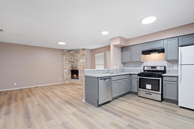 Kitchen featuring gray cabinetry, under cabinet r
