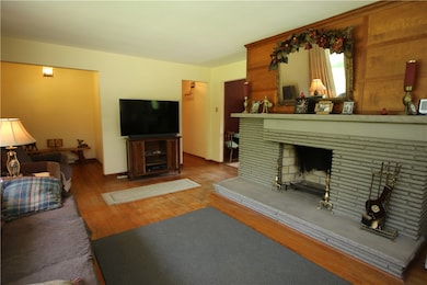 Large 21x15 Living Room w/ Original Hardwood Floors & Stunning Wood Burning Stone Fireplace