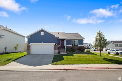 Ranch-style home with concrete driveway, a front yard, brick siding, stucco siding, and a garage