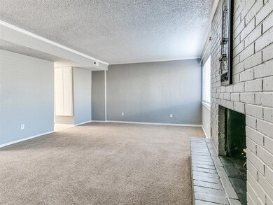 Spacious living room with crown molding, carpet fl