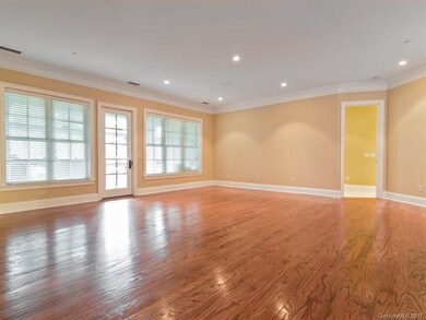 huge great room has gorgeous hardwood floors and a