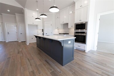 Kitchen featuring stainless steel oven, built in m
