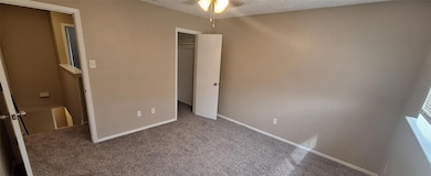 Unfurnished bedroom featuring baseboards, a closet
