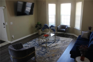 Living area with dark wood-style floors