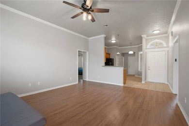 Unfurnished living room featuring a ceiling fan, l